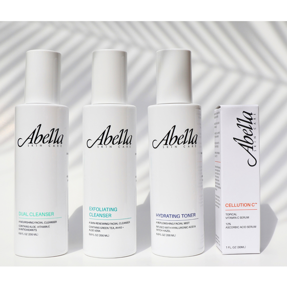Four Abella Skin Care skincare products and their box arranged on a white surface with soft shadow overlays. The set includes Dual Cleanser, Exfoliating Cleanser, Hydrating Toner, and Cellution C Serum.